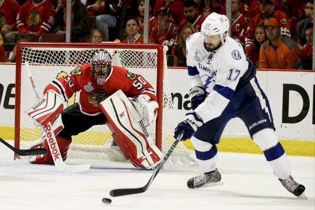 Chicago Blackhawks goalie Corey Crawford, left, keeps his eye on the puck as it's handled by Tampa Bay Lightning's Alex Killorn during the third period in Game 4 of the NHL hockey Stanley Cup Final Wednesday, June 10, 2015, in Chicago. (AP Photo/Nam Y. Huh)