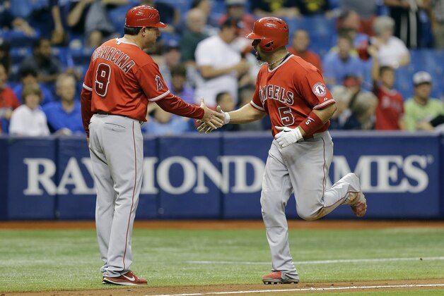 Los Angeles Angels' Albert Pujols (5) shakes hands with third base coach Gary DiSarcina after his two-run home run off Tampa Bay Rays relief pitcher Preston Guilmet during the ninth inning of a baseball game Thursday, June 11, 2015, in St. Petersburg, Fla.  (AP Photo/Chris O'Meara)