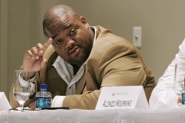 Journalist Jason Whitlock, left tries to get a word in as former NBA all star Alonzo Mourning listens during a panel discussion about  the black athlete, held at Morehouse College, Monday May 7, 2007, in Atlanta. Whitlock took heat during much of the discussion for a newspaper column he wrote condemning fellow panelist Vivian Stringer for her reactions to the infamous Don Imus comments. (AP Photo/John Amis)