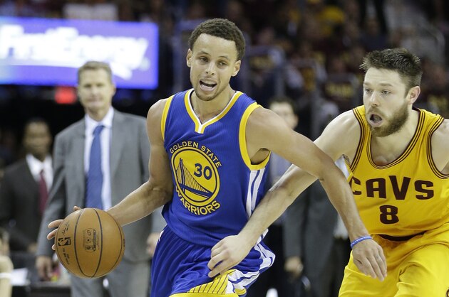 Golden State Warriors guard Stephen Curry (30) drives on Cleveland Cavaliers guard Matthew Dellavedova (8) during the second half of Game 4 of basketball's NBA Finals in Cleveland, Thursday, June 11, 2015. (AP Photo/Tony Dejak)