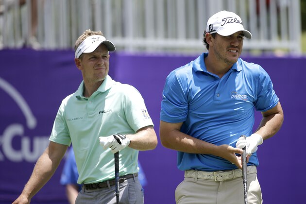Brooks Koepka, right, watches his tee shot on the first hole along with Luke Donald, left, of England, during the second round of the St. Jude Classic golf tournament, Friday, June 12, 2015, in Memphis, Tenn. (AP Photo/Mark Humphrey)