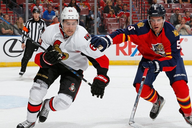 SUNRISE, FL - OCTOBER 13: Mark Stone #61 of the Ottawa Senators and Aaron Ekblad #5 of the Florida Panthers skate after a loose puck at the BB&T Center on October 13, 2014 in Sunrise, Florida. The Senators defeated the Panthers 1-0. (Photo by Joel Auerbach/Getty Images)