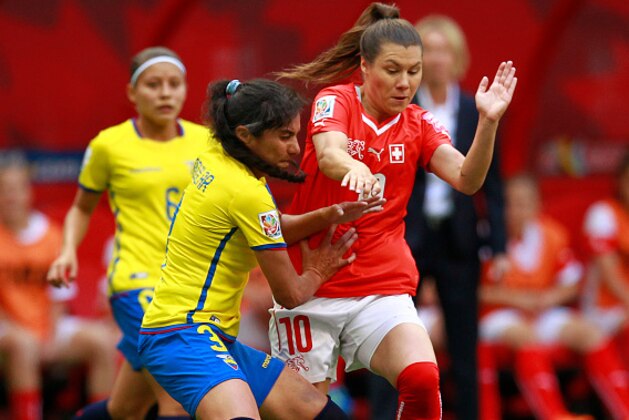 VANCOUVER, BC - JUNE 12:  Ramona Bachmann #10 of Switzerland and Nancy Aguilar #3 of Ecuador battle for the ball during the FIFA Women's World Cup Canada 2015 Group C match between Switzerland and Ecuador June 12, 2015 at BC Place Stadium in Vancouver, British Columbia, Canada.  (Photo by Jeff Vinnick/Getty Images)