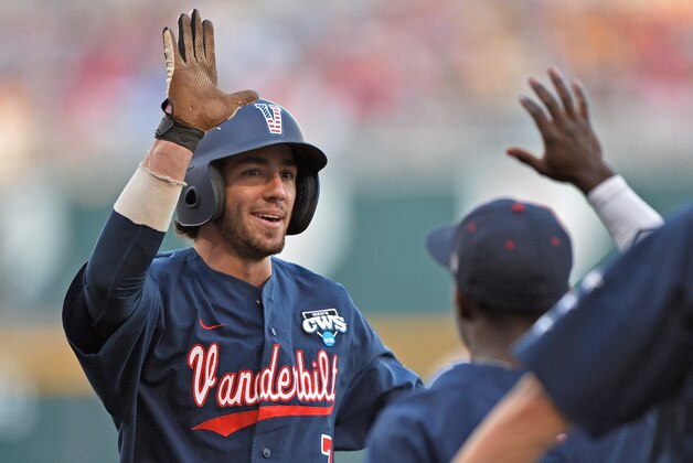 Omaha, NE - JUNE 23:  Second basemen Dansby Swanson #7 of the Vanderbilt Commodores celebrates with his teammates after scoring against the Virginia Cavaliers in the third inning during game one of the College World Series Championship on June 23, 2014 at TD Ameritrade Park in Omaha, Nebraska.  (Photo by Peter Aiken/Getty Images)