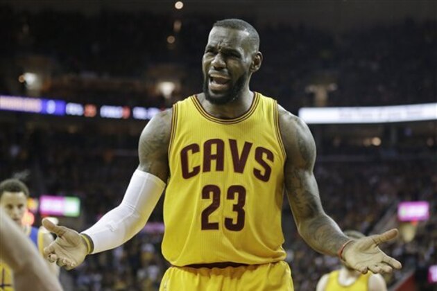 Cleveland Cavaliers forward LeBron James (23) questions a call during the first half of Game 4 of basketball's NBA Finals against the Golden State Warriors in Cleveland, Thursday, June 11, 2015. (AP Photo/Tony Dejak)