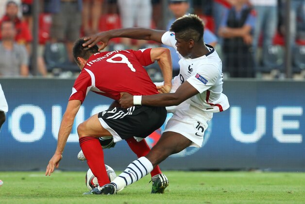 France's Payl Pogba, right, vies for the ball with Albania's  Ledion Memusha, during the friendly international soccer match between Albania and France, in the central city of Elbasan, Albania, Saturday, June 13, 2015. (AP Photo/Hektor Pustina)