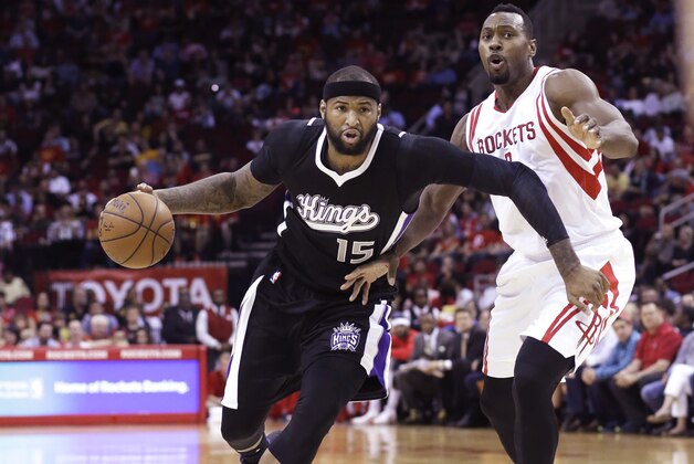 Sacramento Kings' DeMarcus Cousins (15) drives the ball past Houston Rockets' Joey Dorsey in the first half of an NBA basketball game Wednesday, April 1, 2015, in Houston. (AP Photo/Pat Sullivan)