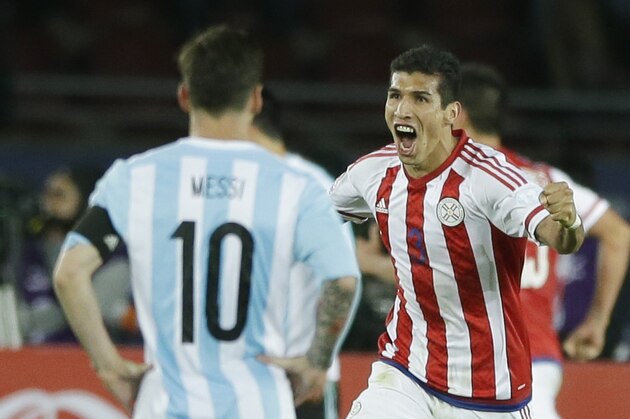 Paraguay's Marcos Caceres, back, celebrates after his teammate Lucas Barrios scoring against Argentina as Lionel Messi  looks on during a Copa America Group B soccer match at La Portada stadium in La Serena, Chile, Saturday, June 13, 2015. (AP Photo/Ricardo Mazalan)