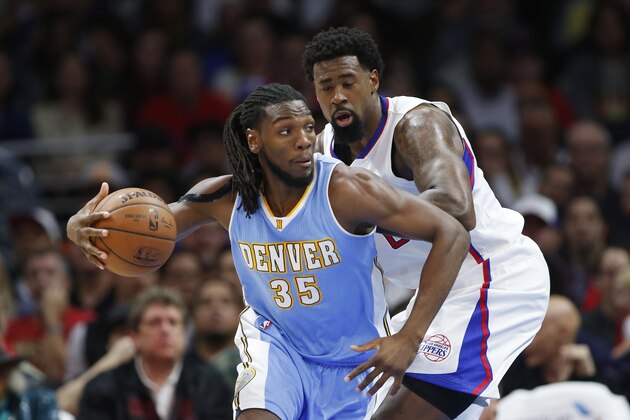 Denver Nuggets' Kenneth Faried, left, dribbles around Los Angeles Clippers' DeAndre Jordan, right, during the first half of an NBA basketball game, Monday, April 13, 2015, in Los Angeles. (AP Photo/Danny Moloshok)