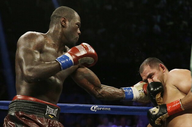 Deontay Wilder, left,  punches Eric Molina during the WBC heavyweight boxing match, Saturday, June 13, 2015, in Birmingham, Ala. (AP Photo/Brynn Anderson)