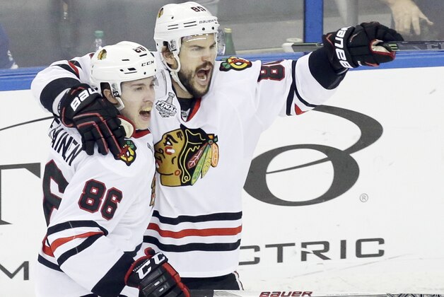 Chicago Blackhawks center Antoine Vermette (80) celebrates with left wing Teuvo Teravainen (86) after scoring a goal against the Tampa Bay Lightning during the third period of Game 5 of the NHL hockey Stanley Cup Final, Saturday, June 13, 2015, in Tampa, Fla. (AP Photo/John Raoux)