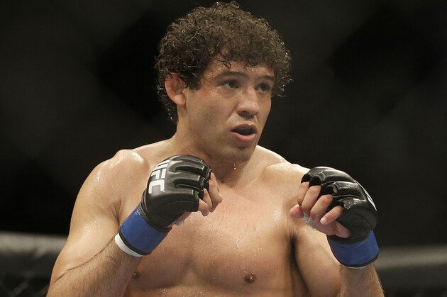 Gilbert Melendez fights Benson Henderson in a UFC lightweight championship mixed martial arts fight in San Jose, Calif., Saturday, April 20, 2013. Henderson won by split decision to retain the championship. (AP Photo/Jeff Chiu)