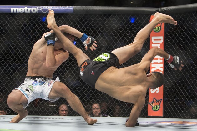 Charles Rosa, left, of the United States battles against Mexico´s Yair Rodriguez during a men's Featherweight  UFC 188 mixed martial arts bout in Mexico City, Saturday, June  13, 2015. Rodriguez won the fight by decision. (AP Photo/Christian Palma)