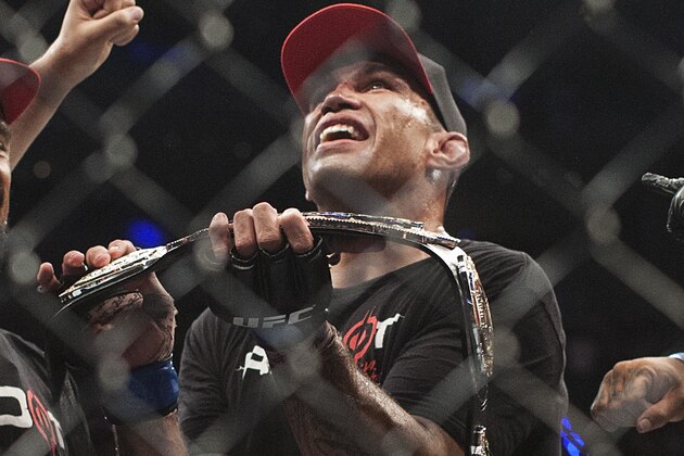 Brazil´s Fabricio Werdum celebrates after beating United States´ Cain Velasquez in a men's mixed martial arts UFC 188 heavyweight title fight in Mexico City, Saturday, June  13, 2015. Werdum won the fight by submission. (AP Photo/Christian Palma)
