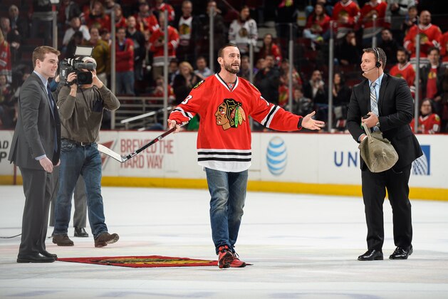 CHICAGO, IL - MARCH 30:  Former WWE wrestler CM Punk reacts after shooting the puck in between periods of the NHL game between the Los Angeles Kings and the Chicago Blackhawks at the United Center on March 30, 2015 in Chicago, Illinois.  (Photo by Bill Smith/NHLI via Getty Images)