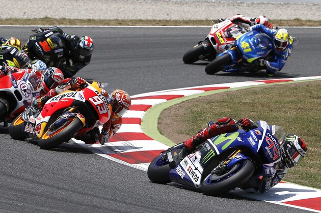Moto GP rider Jorge Lorenzo of Spain, right, leads the race during the Catalunya Motorcycle Grand Prix at the Barcelona Catalunya racetrack in Montmelo, near Barcelona, Spain, on Sunday, June 14, 2015. (AP Photo/Manu Fernandez)