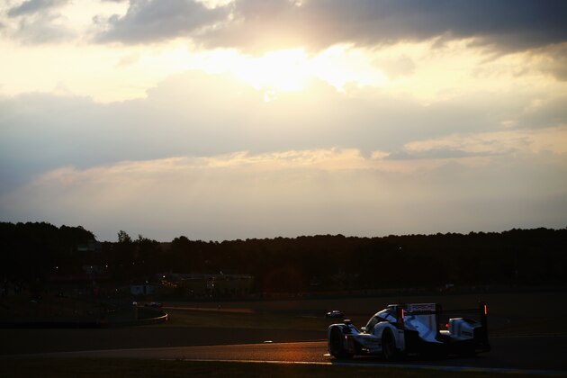 LE MANS, FRANCE - JUNE 14:   The Porsche Team 919 Hybrid of Earl Bamber, Nick Tandy and Nico Hulkenburg drives at sunrise during the Le Mans 24 Hour race at the Circuit de la Sarthe on June 14, 2015 in Le Mans, France.  (Photo by Ker Robertson/Getty Images)
