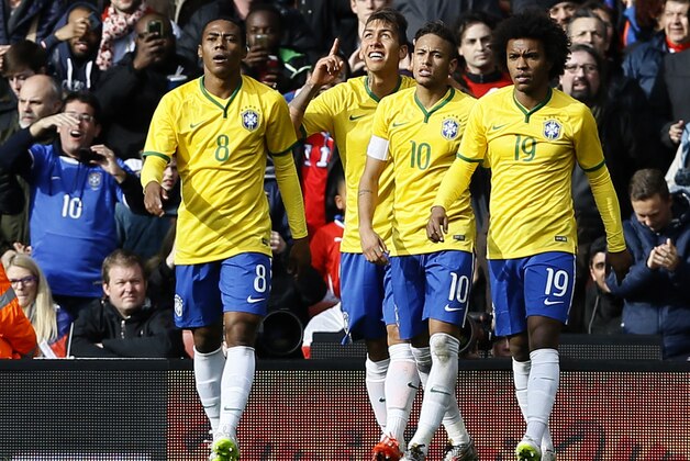 Brazil’s Firmino, second left, celebrates after scoring the opening goal of the game during the international friendly soccer match soccer match between Brazil and Chile at the Emirates stadium in London, Sunday, March 29, 2015. (AP Photo/Kirsty Wigglesworth)