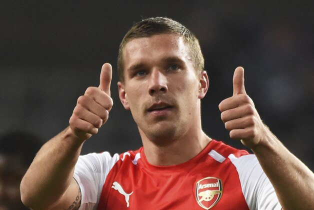 Arsenal's Lukas Podolski gives two thumbs up at the end of the Group D Champions League match between Anderlecht and Arsenal at Constant Vanden Stock Stadium in Brussels, Belgium, Wednesday Oct. 22, 2014. Arsenal won the match with a 2-1 score. (AP Photo/Geert Vanden Wijngaert)