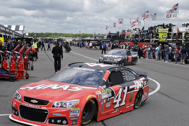 Kurt Busch (14) and Martin Truex Jr. (78) drive through the garage area at Pocono Raceway during practice for Sunday's NASCAR Sprint Cup Series auto race in Long Pond, Pa., Saturday, June 6, 2015. (AP Photo/Mel Evans)