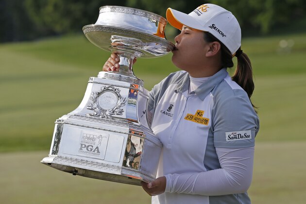 Inbee Park, of South Korea, kisses the trophy after winning the KPMG Women's PGA golf championship at Westchester Country Club in Harrison, N.Y., Sunday, June 14, 2015. (AP Photo/Julio Cortez)