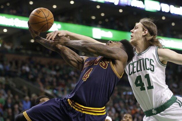 Cleveland Cavaliers guard Iman Shumpert, left, drives toward the basket as Boston Celtics center Kelly Olynyk, right, reaches for the ball in the fourth quarter of a first-round NBA playoff basketball game in Boston, Sunday, April 26, 2015. The Cavaliers won 101-93 to complete a first-round sweep of the Celtics. (AP Photo/Steven Senne)