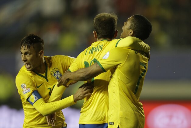 Brazil's Douglas Costa, right, celebrate after scoring against Peru with his teammates Brazil's Neymar, left, and Brazil's Everton Ribeiro during a Copa America Group C soccer match at the Bicentenario Germán Becker stadium in Temuco, Chile, Sunday, June 14, 2015. Brazil won the match 2-1. (AP Photo/Jorge Saenz)