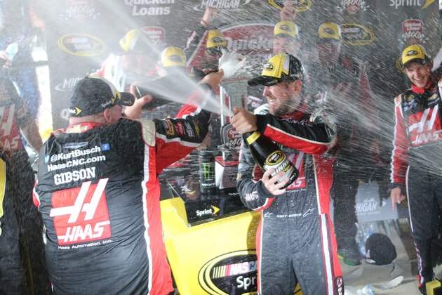 Kurt Busch celebrates with teammates after winning the NASCAR Sprint Cup series auto race at Michigan International Speedway, Sunday, June 14, 2015, in Brooklyn, Mich. (AP Photo/Bob Brodbeck)