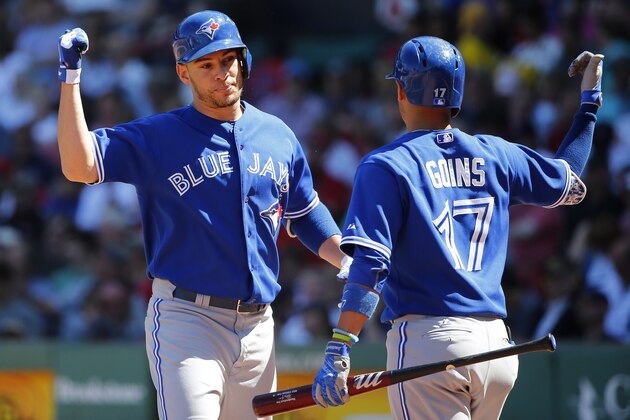 BOSTON, MA - June 14:  Danny Valencia #23 of the Toronto Blue Jays and Ryan Goins #17 of the Toronto Blue Jays celebrate after Valencia's two-run home run against the Boston Red Sox during the fifth inning of the game at Fenway Park on June 14, 2015 in Boston, Massachusetts.  (Photo by Winslow Townson/Getty Images)