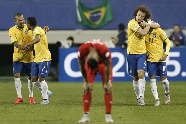 Brazil's Douglas Costa, second left, celebrates his goal against Peru with teammate Brazil's Dani Alves, left, as Brazil's David Luiz, second right, hugs Brazil's Neymar, right, during a Copa America Group C soccer match at the German Becker stadium in Temuco, Chile, Sunday, June 14, 2015. Brazil won the match 2-1. (AP Photo/Silvia Izquierdo)