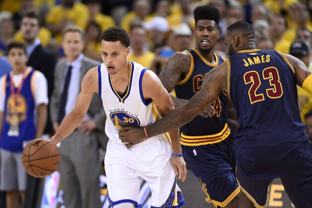 Jun 14, 2015; Oakland, CA, USA; Golden State Warriors guard Stephen Curry (30) brings the ball up court against Cleveland Cavaliers forward LeBron James (23) during the fourth quarter in game five of the NBA Finals at Oracle Arena. Mandatory Credit: Bob Donnan-USA TODAY Sports