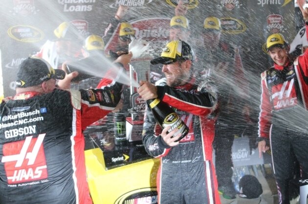 Kurt Busch celebrates with teammates after winning the NASCAR Sprint Cup series auto race at Michigan International Speedway, Sunday, June 14, 2015, in Brooklyn, Mich. (AP Photo/Bob Brodbeck)