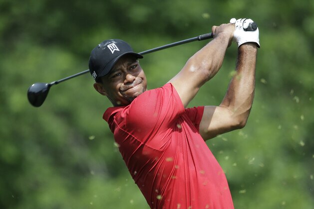 Tiger Woods tees off on the 18th hole during the final round of the Memorial golf tournament Sunday, June 7, 2015, in Dublin, Ohio. (AP Photo/Darron Cummings)