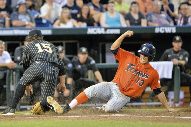 Cal State Fullerton's Timmy Richards (13) scores on a wild pitch as Vanderbilt pitcher Carson Fulmer (15) waits for the ball in the fifth inning of an NCAA College World Series baseball game at TD Ameritrade Park in Omaha, Neb., Sunday, June 14, 2015. (AP Photo/Ted Kirk)