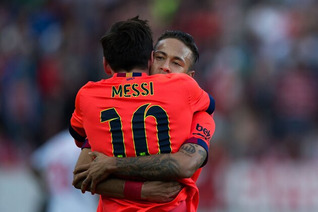 SEVILLE, SPAIN - APRIL 11:  Lionel Messi (L) of FC Barcelona celebrates scoring their opening goal with teammate Neymar JR. (R) during the La Liga match between Sevilla FC and FC Barcelona at Estadio Ramon Sanchez Pizjuan on April 11, 2015 in Seville, Spain.  (Photo by Gonzalo Arroyo Moreno/Getty Images)