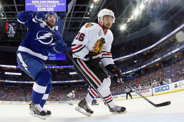TAMPA, FL - JUNE 13:  Braydon Coburn #55 of the Tampa Bay Lightning skates in front of the net against Marcus Kruger #16 of the Chicago Blackhawks during Game Five of the 2015 NHL Stanley Cup Final at Amalie Arena on June 13, 2015 in Tampa, Florida.  (Photo by Bruce Bennett/Getty Images)