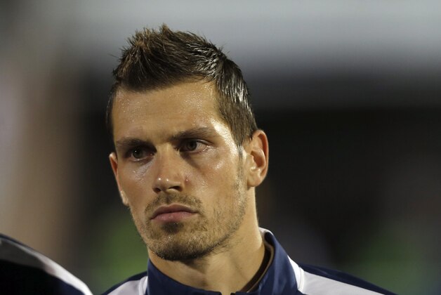 France's Morgan Schneiderlin stands during the playing of his country's national anthem before the start of their international friendly soccer match against Serbia, in Belgrade, Serbia, Sunday, Sept. 7, 2014. (AP Photo/Darko Vojinovic)