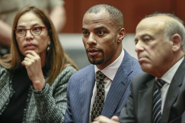 Former NFL safety Darren Sharper, center, with his attorneys, Lisa Wayne, left, and Leonard Levine, right, appear in Los Angeles Superior Court on Monday, March 23, 2015. Sharper was sentenced to nine years in federal prison Monday immediately after he pleaded guilty to sexually assaulting a woman in Arizona, marking the first change of plea of the day for the former safety accused of drugging and assaulting women in four states. (AP Photo/Nick Ut, Pool)