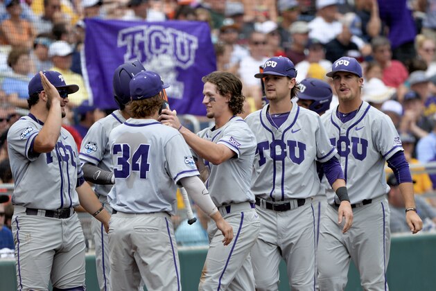 TCU's Cody Jones, center, is greeted by teammates after he scored on a single by TCU designated hitter Connor Wanhanen in the fourth inning of an NCAA College World Series baseball game against LSU at TD Ameritrade Park in Omaha, Neb., Sunday, June 14, 2015. (AP Photo/Ted Kirk)