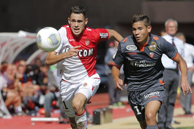 Monaco's Lucas Ocampos of Argentina, left, challenges for the ball with Lorient's Raphael Guerreiro of France during their French League One soccer match, in Monaco stadium, Sunday, Sept. 15, 2013. (AP Photo/Lionel Cironneau)