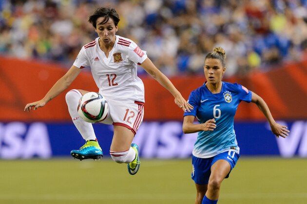 MONTREAL, QC - JUNE 13:  Marta Corredera #12 of Spain jumps for the ball with Tamires #6 of Brazil running behind her during the 2015 FIFA Women's World Cup Group E match at Olympic Stadium on June 13, 2015 in Montreal, Quebec, Canada. (Photo by Minas Panagiotakis/Getty Images)