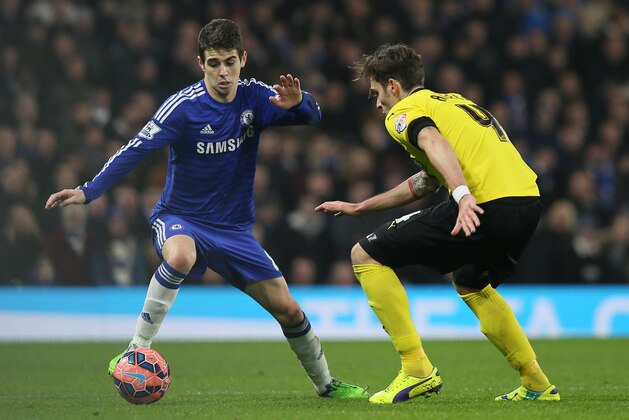 Chelsea’s Oscar, left, competes for the ball with Watford’s Gabriele Angella during their English FA Cup third round soccer match Chelsea and Watford at Stamford Bridge in London, England, Sunday, Jan. 4, 2015. (AP Photo/Tim Ireland)