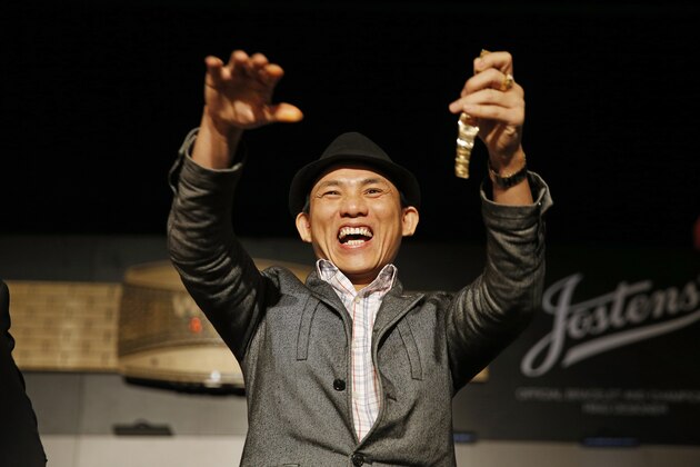 Christian Pham celebrates during a bracelet ceremony after he won the World Series of Poker No-Limit Deuce-to-Seven Lowball Draw tournament Friday, June 12, 2015, in Las Vegas. Pham accidentally entered the No-Limit Deuce-to-Seven Lowball Draw tournament while trying to register for another. (AP Photo/John Locher)