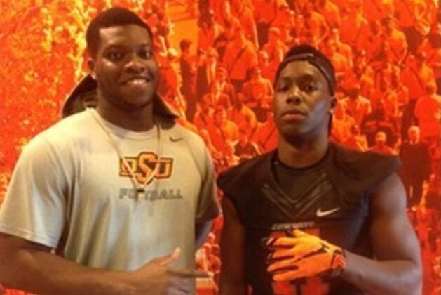 Amen Ogbongbemiga (right) poses with his cousin, Big 12 Defensive Lineman of the Year Emmanuel Ogbah. Ogbongbemiga has built a reputation as a 2016 linebacker in Canada. He picked up his first Power Five offer over the weekend from Oklahoma State.
