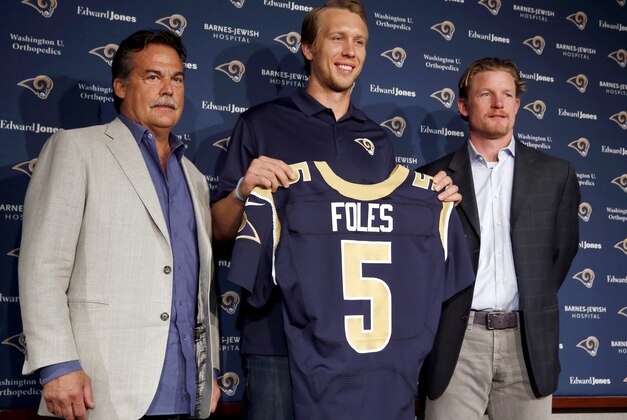 Nick Foles, center, is introduced as the new St. Louis Rams quarterback by Rams head coach Jeff Fisher, left, and general manger Les Snead, right, during an NFL fooball news conference Friday, March 13, 2015, in St. Louis. Foles was traded to the Rams earlier this week, with Sam Bradford going to the Philadelphia Eagles in a quarterback swap. (AP Photo/Jeff Roberson)