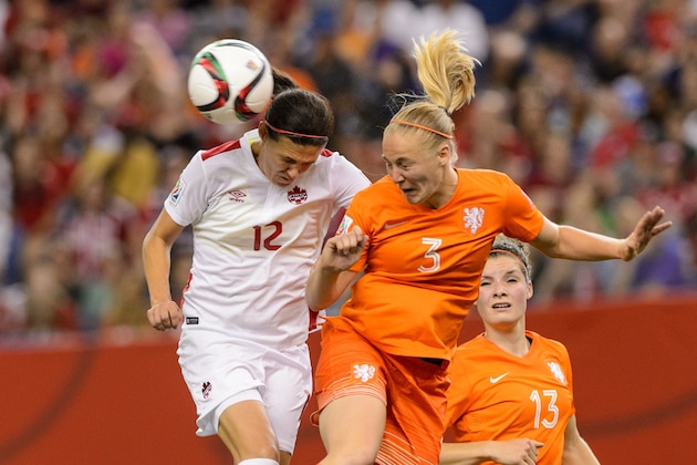 MONTREAL, QC - JUNE 15:  Christine Sinclair #12 of Canada and Stefanie Van Der Gragt #3 of the Netherlands jump for the ball during the 2015 FIFA Women's World Cup Group A match at Olympic Stadium on June 15, 2015 in Montreal, Quebec, Canada.  Final score between Canada and the Netherlands 1-1. (Photo by Minas Panagiotakis/Getty Images)