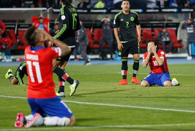 Chile's Jorge Valdivia, right, and Eduardo Vargas, left, react during a Copa America Group A soccer match against Mexico at El Nacional stadium in Santiago, Chile, Monday, June 15, 2015. The match ended in a 3-3 draw. (AP Photo/Silvia Izquierdo)