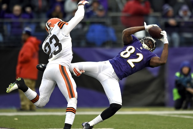 Baltimore Ravens wide receiver Torrey Smith, right, makes a catch for a first down in front of Cleveland Browns cornerback Joe Haden in the second half of an NFL football game, Sunday, Dec. 28, 2014, in Baltimore. (AP Photo/Gail Burton)