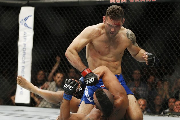 Chris Weidman pounds Vitor Belfort during their middleweight mixed martial arts bout at UFC 187 Saturday, May 23, 2015, in Las Vegas. (AP Photo/John Locher) Chris Weidman pounds Vitor Belfort during their middleweight mixed martial arts bout at UFC 187 Saturday, May 23, 2015, in Las Vegas. (AP Photo/John Locher)