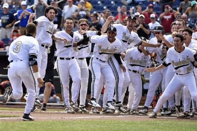 Vanderbilt players celebrate as Jeren Kendall (3) approaches home plate after hitting the game-winning two-run home run in the bottom of the ninth inning of an NCAA College World Series baseball game against Cal State Fullerton at TD Ameritrade Park in Omaha, Neb., Monday, June 15, 2015. Vanderbilt won 4-3. (AP Photo/Mike Theiler)